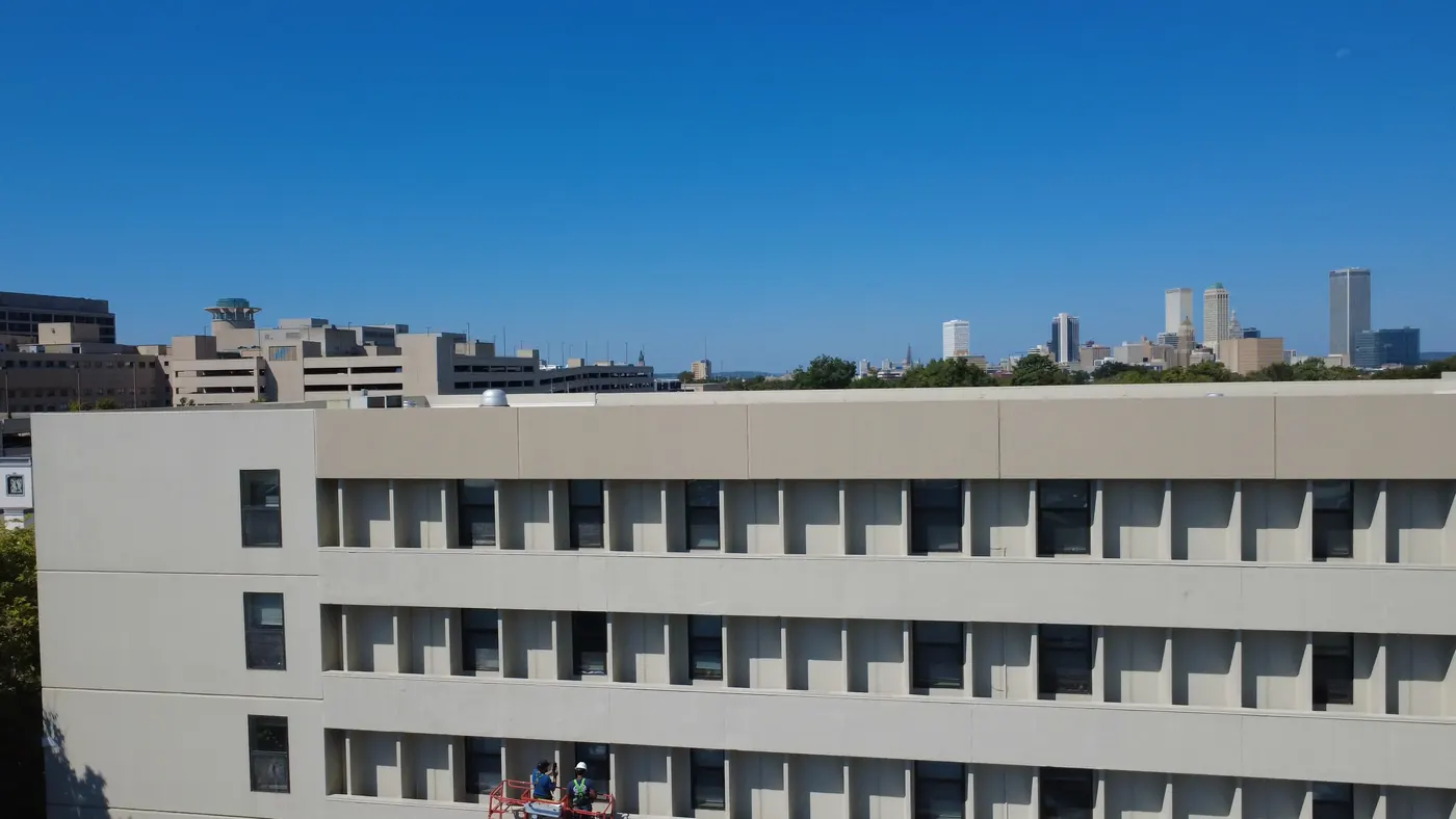The commercial building under works with the downtown Tulsa skyline behind it